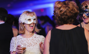 Corporate event photo with holiday masquerade ball