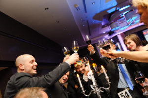 Employees toast in holiday event photos